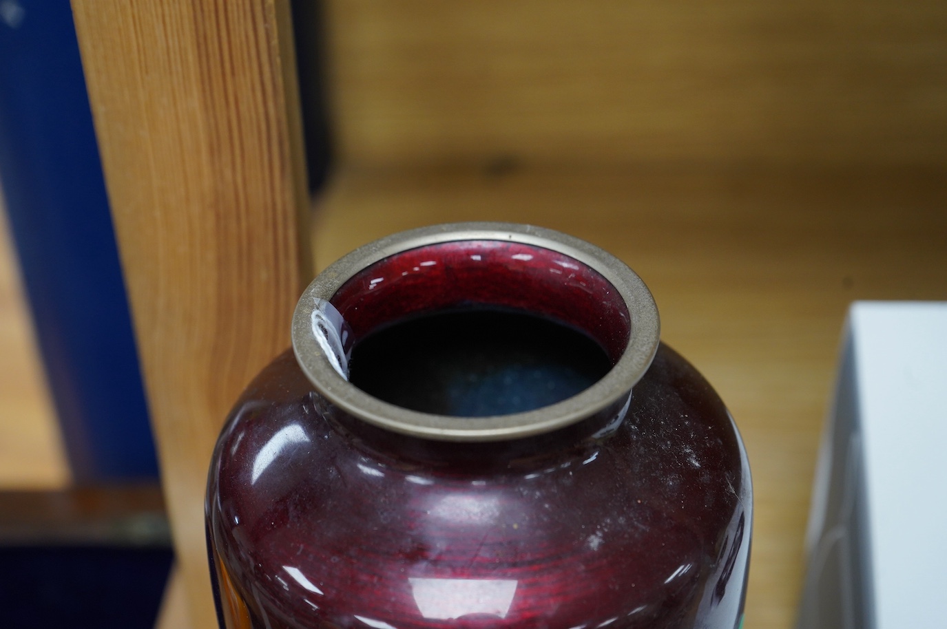 A mid 20th century Japanese cloisonné enamel red ginbari ground vase, decorated with cranes, 21cm high. Condition - fair to good